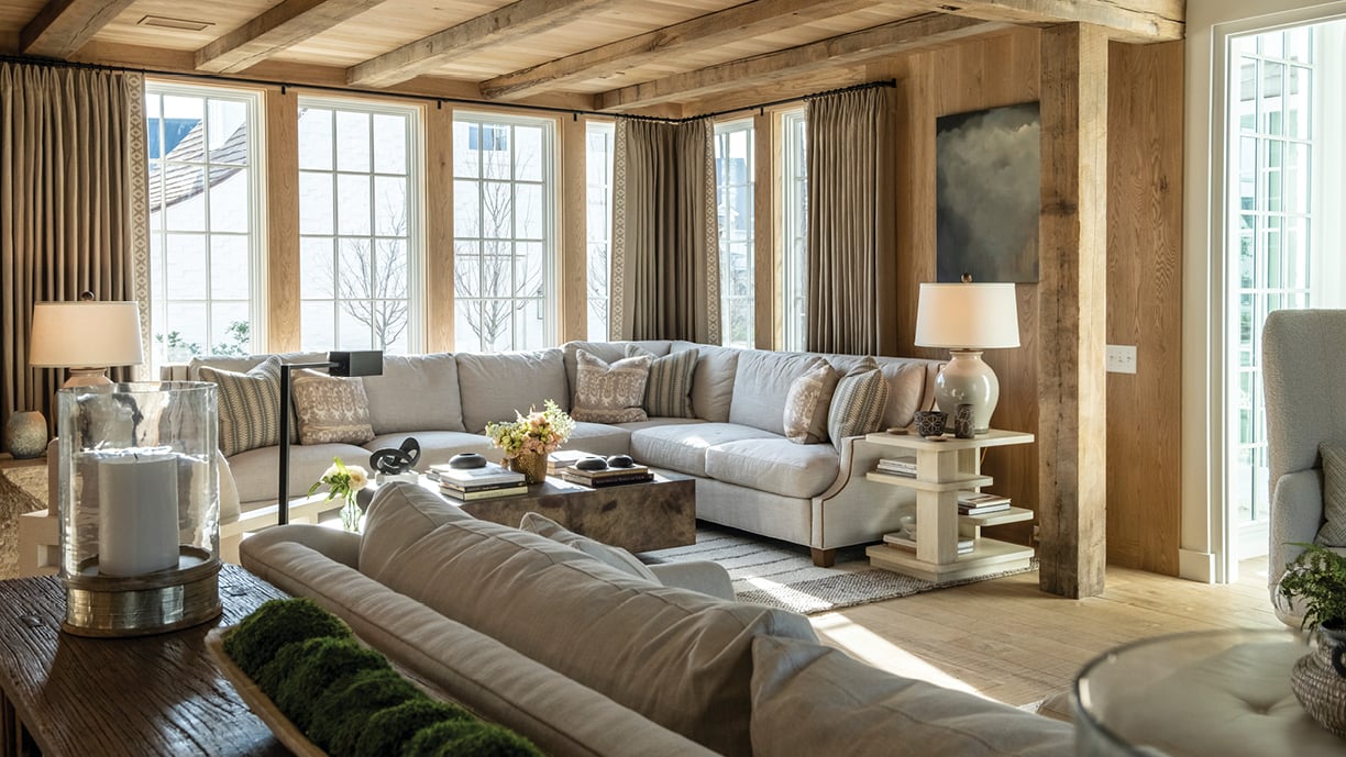 Living room featuring Andersen A-Series transom and picture windows with Stormwatch Protection in white/white with colonial grilles.