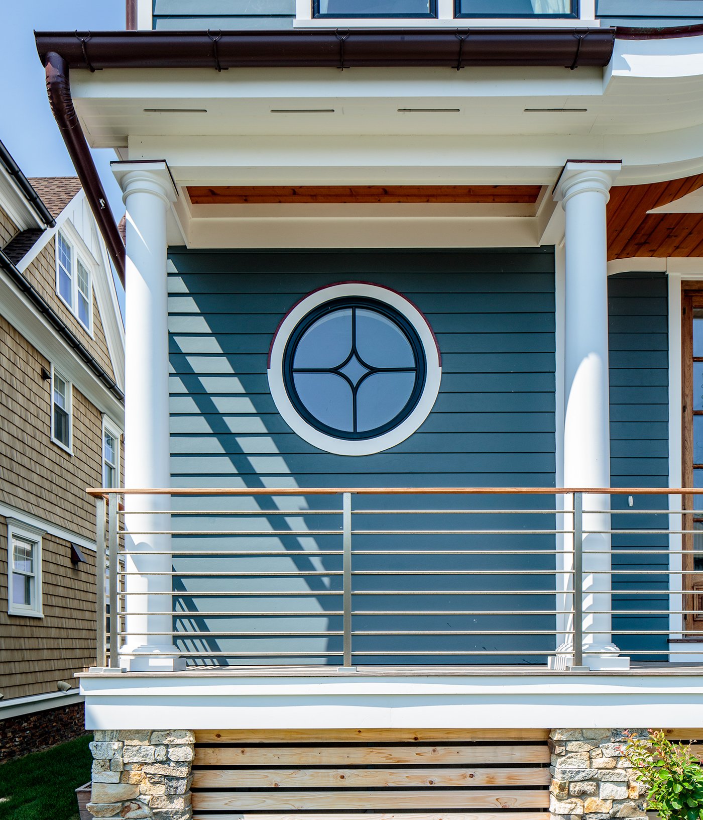 A traditional home with an Andersen® 400 Series Specialty Window in a circle shape.