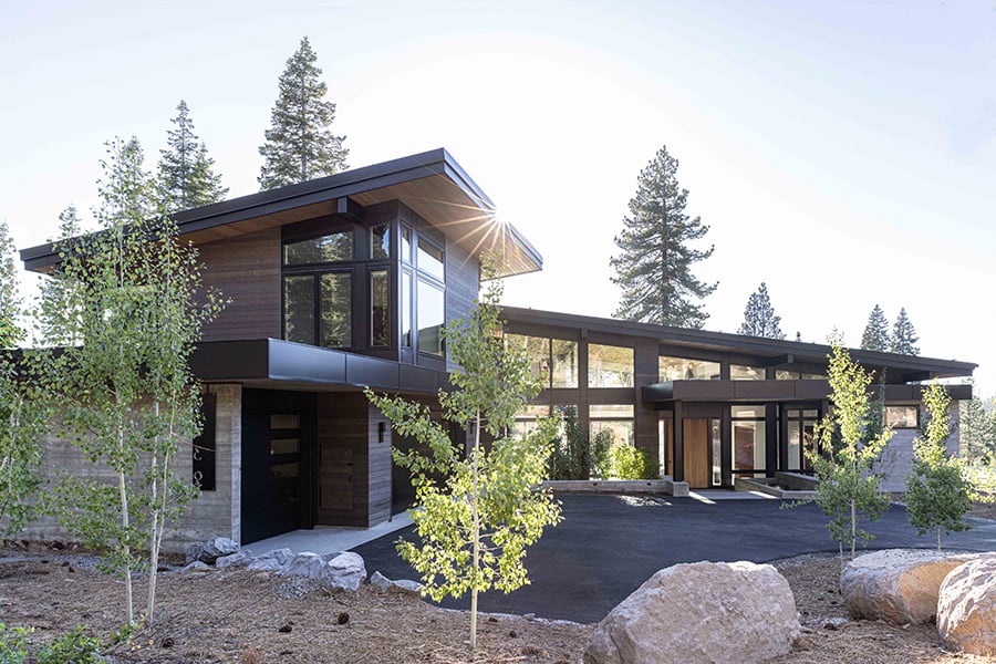 Modern style home with low pitch roof and an abundance of windows