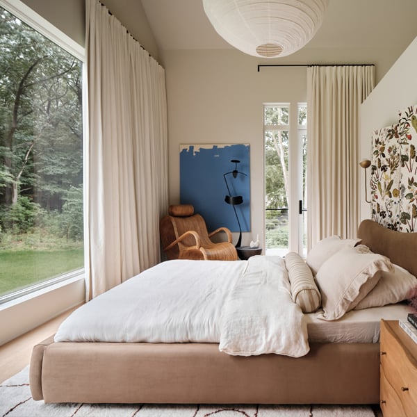 Bedroom with large picture windows and floral headboard