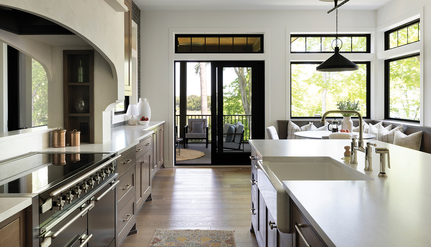 A kitchen with an Andersen 100 Series Gliding Patio Door connecting with a screened-in porch.
