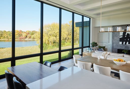 Living and dining area with floor to ceiling windows picture on top of awning